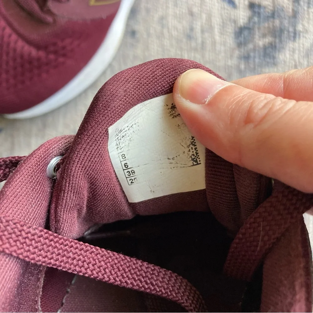 New Balance women’s Burgundy Sneakers with Gold Accent